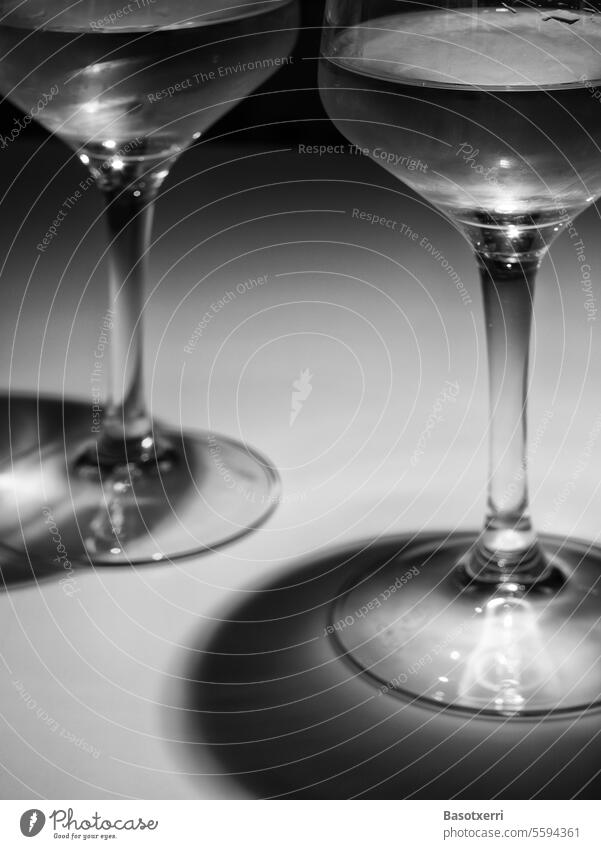Close-up of two white wine glasses (detail view) with shallow depth of field in interesting light, black and white shot with light and shadow Vine Wine glass