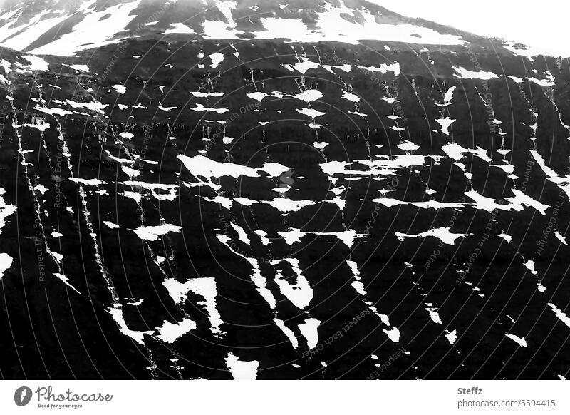 Snow tracks on a mountain side in Iceland Icelandic Traces of snow Snow melt residual snow Mountain side Rock Hill Icelandic nature Icelandic landscape