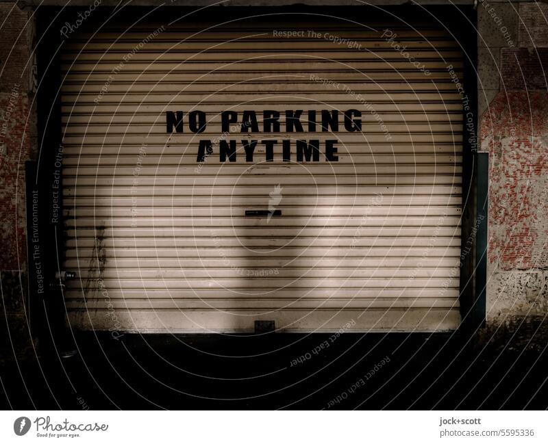 PARKING PROHIBITED AT ALL TIMES no parking anytime Garage door Closed Shadow Light (Natural Phenomenon) Capital letter Signs and labeling Clearway English Bans