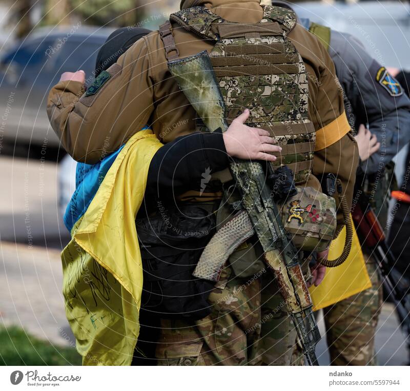 Ukraine, Kherson - November 14, 2022: A boy hugs a Ukrainian soldier on the day the city was liberated from Russian occupation kherson adult army body