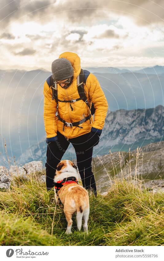 sports and activities in the nature man dog adult hike travel climbing summit adventure couple mountain trekking healthy hiker people hill happy outdoor