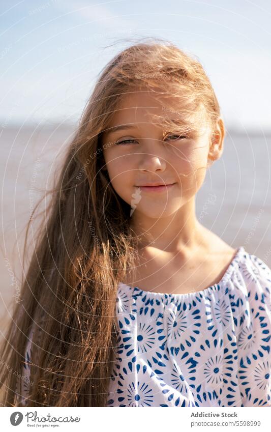 Portrait Adorable child girl with long hair emotions children family sunset outdoors landscape seaside morning relax sunlight water portrait vacation summer