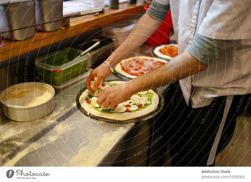 Pizza man adding ingredients to pizza unrecognizable food pizzeria cheese spinach zucchini sauce restaurant kitchen preparing italian cooking baker person ham