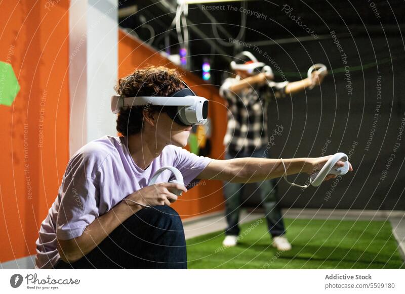 Young adults immersed in a virtual reality gaming session vr headset controller arcade technology experience immersive young interaction intense fun
