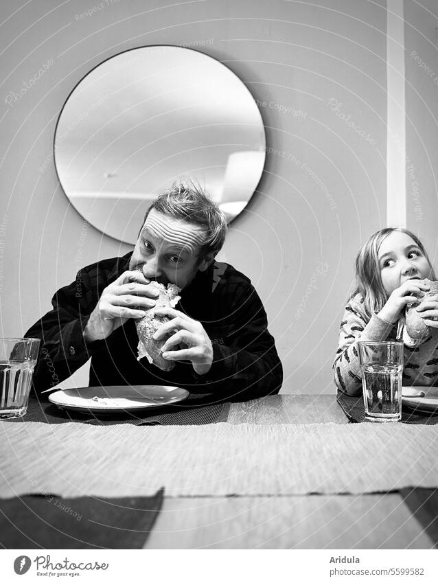Man and child eating a croque at the dining table b/w Eating Child Baguette Bread Delicious Mouth eyes hunger Looking Appetite Nutrition Dinner table Sandwich