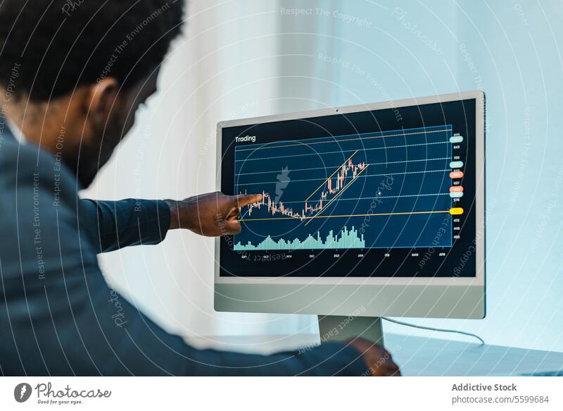 Black man analyzing financial diagrams on binary option trader broker point graph online statistic male black african american ethnic computer analyze analyst