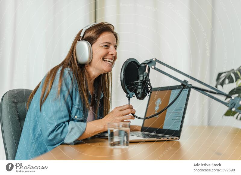 Happy woman recording podcast and speaking in mic talk microphone smile radio broadcast host laptop female studio entertain connection positive device using