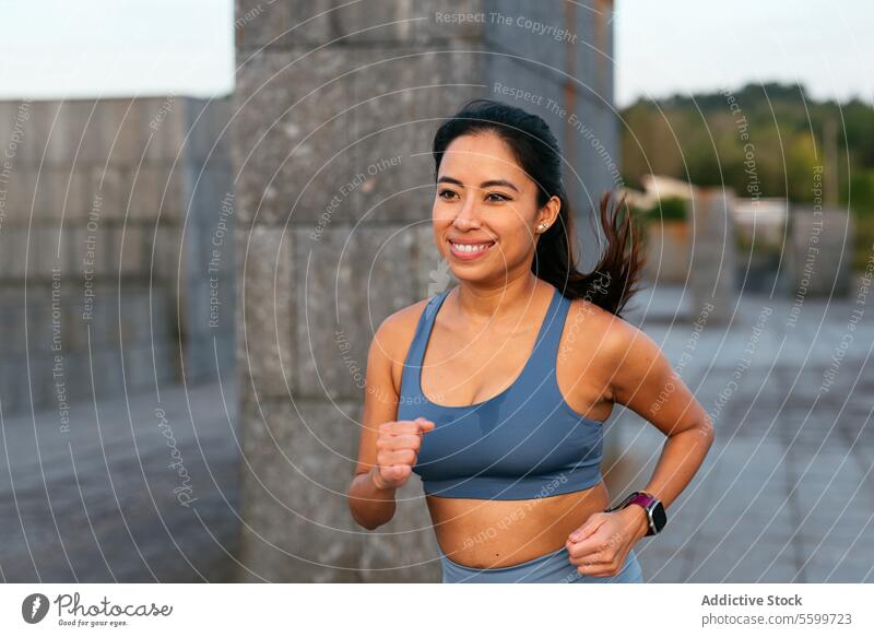 Joyful Latin American Woman Enjoying Outdoor Running workout woman latin american running outdoor active lifestyle exercise fitness smile attire positivity
