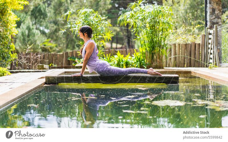 Woman practicing yoga, lying in Cobra pose (Bhujangasana exercise) outdoors aesthetic balance bridge calmness cobra concentration confidence copy space