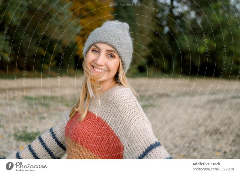 Happy woman with arms outstretched wearing knitwear and hat enjoyment horizontal relaxation carefree one person smile warm canada vitality walk freedom weather