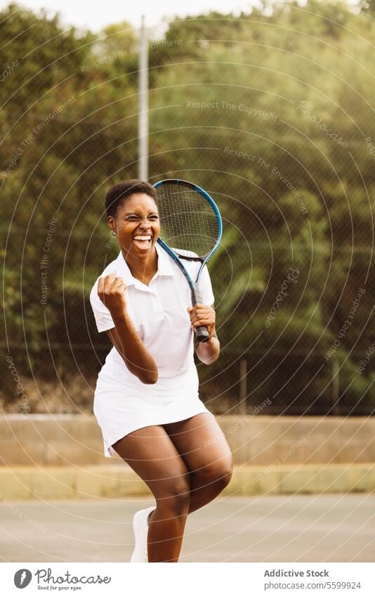 Woman celebrating a point during a tennis match active lifestyle activity amateur beautiful beautiful women celebration cheerful competition court effusive