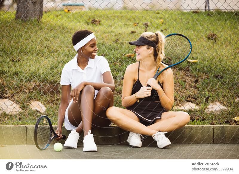 Young beautiful women getting ready for a tennis match. active lifestyle activity amateur athlete ball cheerful competition court diversity enjoyment exercise