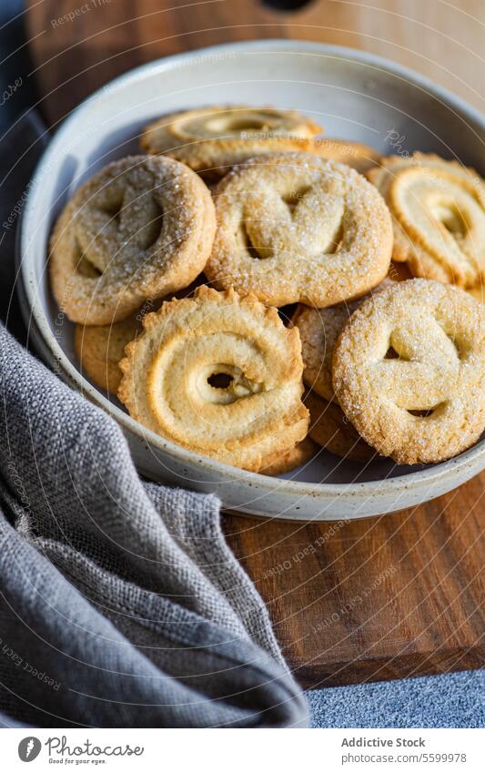 Top view of homemade butter cookies on a wooden board gray napkin minimalist baked bowl snack pastry sweet comfort food treat biscuit culinary cuisine bakery