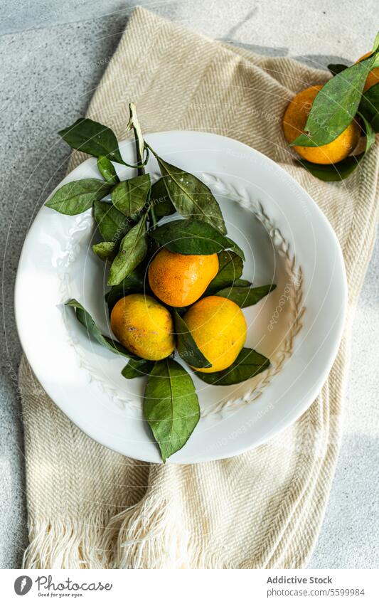 Rustic Charm with Citrus Accents rustic charm tangerine citrus white plate textured beige napkin simplicity fresh fruit organic tableware classic natural