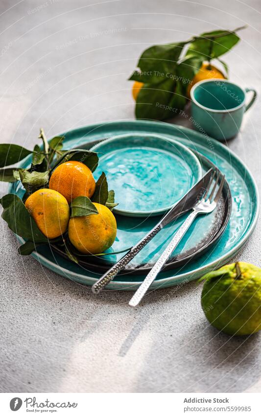 Citrus Elegance on Aqua Plate citrus aqua plate ripe composition natural freshness tangerine ceramic fruit leaf tableware elegance textured gourmet vibrant