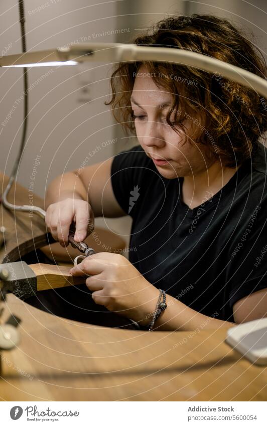 Focused adult craftswoman working in jewelry atelier occupation manufacturing expertise desk creativity photography one person skill businesswoman inspiration