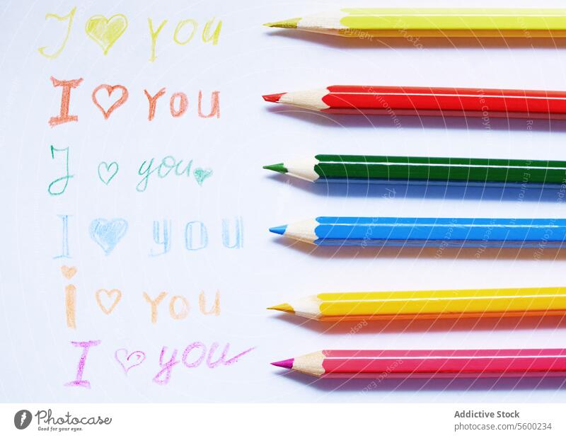 Love you pencil drawing letter colorful sharp multicolored vibrant heart Valentine Day wood horizontal paper inscription handwriting text message romance
