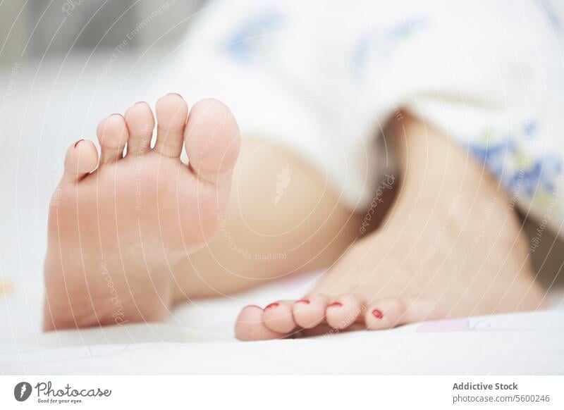 Feet of sleeping woman Foot leg finger pedicure body part limb close-up bedroom linen resting human lifestyle purity serenity domestic home indoors blanket