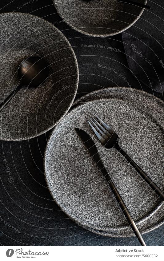 Elegant tableware set on a dark background plate utensil texture elegant modern artistic cutlery arrangement surface dinnerware dish fork spoon dining ceramic