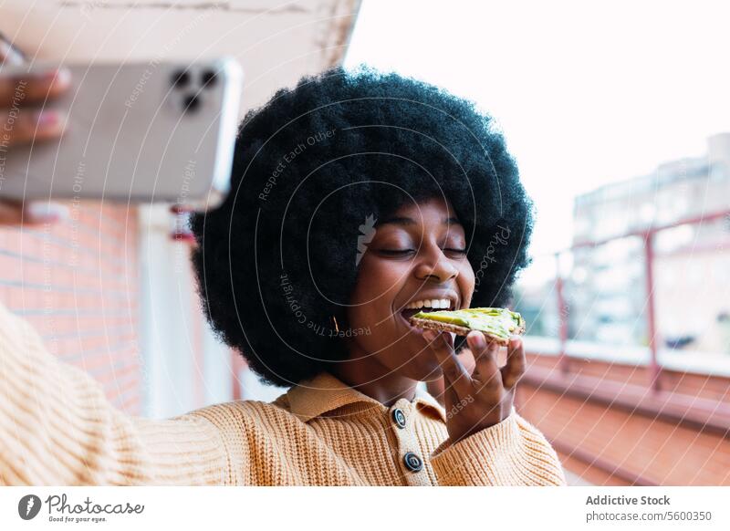 Black woman taking selfie with avocado toast take photo food smartphone using breakfast social media healthy lifestyle morning female african american black