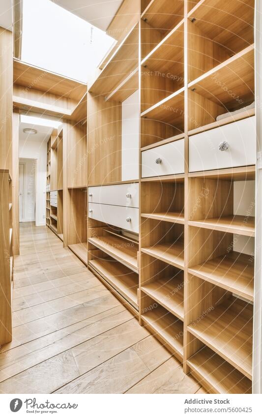 Modern walk in large empty wardrobe with wooden shelves shelf house luxurious hardwood floor narrow closet contemporary furniture home neat rack shelving