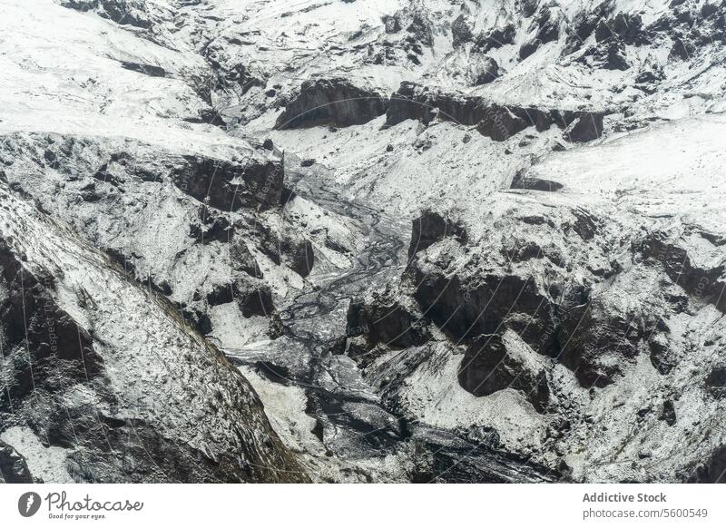Aerial view of rocky terrain snowy landscape rocks rugged contrast harsh beauty complexity winter nature cold outdoor stark frost wilderness white desolate