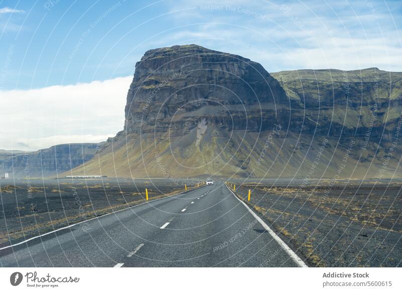 Open road through the dramatic landscapes of Iceland's Highlands iceland highland mountain rugged serene view open road stark beauty terrain scale desolate