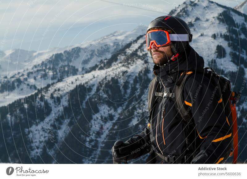 Adventurer ready for a Swiss Alps expedition adventurer skier goggles helmet backpack swiss alps snow mountain winter sport outdoor alpine scenic landscape