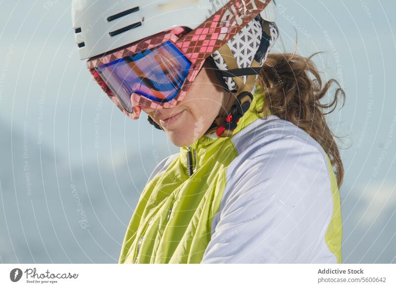 Female skier in helmet and goggles at Swiss Alps female swiss alps close-up fashion mountain adventure sport winter skiwear protective gear active outdoor snow