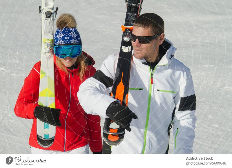 Couple enjoying a sunny day skiing in the Swiss Alps skier couple swiss alps mountain snow winter sport leisure outdoor sunshine vacation travel active