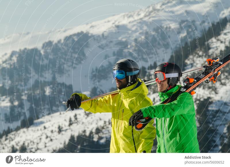 Skiers preparing for descent in the Swiss Alps skier swiss alps winter sport snow slope mountain preparation ski gear outdoor activity cold adventure alpine