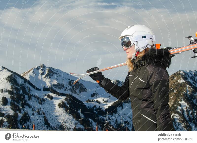 Skier preparing for descent in the Swiss Alps skier equipment snow swiss alps woman mountain ski gear helmet goggles outdoor winter sport activity cold nature