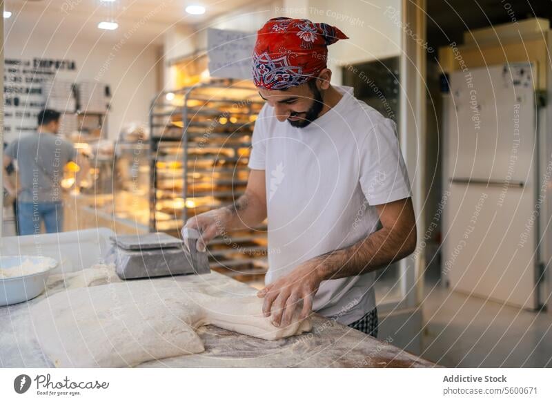 Arabic baker cutting dough with scapula arabic bread scale weighting preparation bakery making happy smile flour raw table fresh cutter utensil pastry working