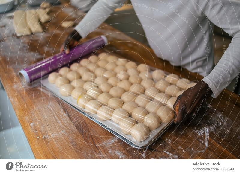 Portrait of dough balls in tray portrait close-up hands lifting bread bakery food flour wheat fresh yeast tasty business production making preparing working