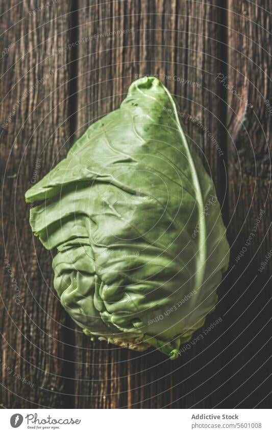 Close up of raw whole cabbage at rustic brown wooden background. Top view. close up top view closeup food fresh garden green harvest harvesting healthy