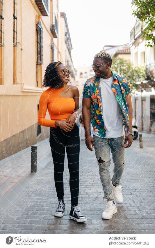 Young black friends walking in the street young couple smiling happy lifestyle outdoor urban casual man woman portrait person city adult communication outdoors