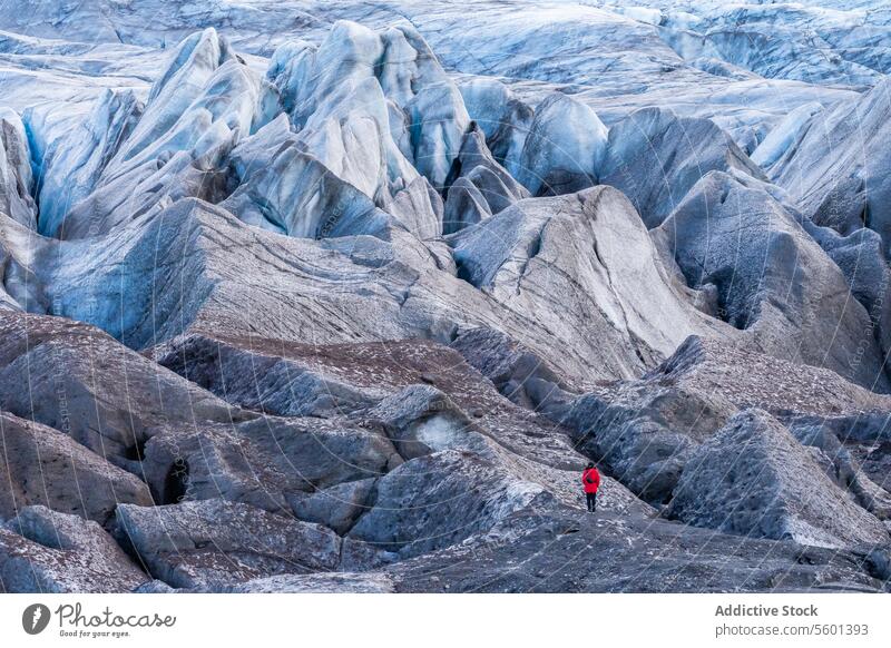 Small figure against vast glacier in VatnajÃ¶kull, Iceland explorer vatnajÃ¶kull national park iceland landscape scale beauty icy terrain adventure travel blue