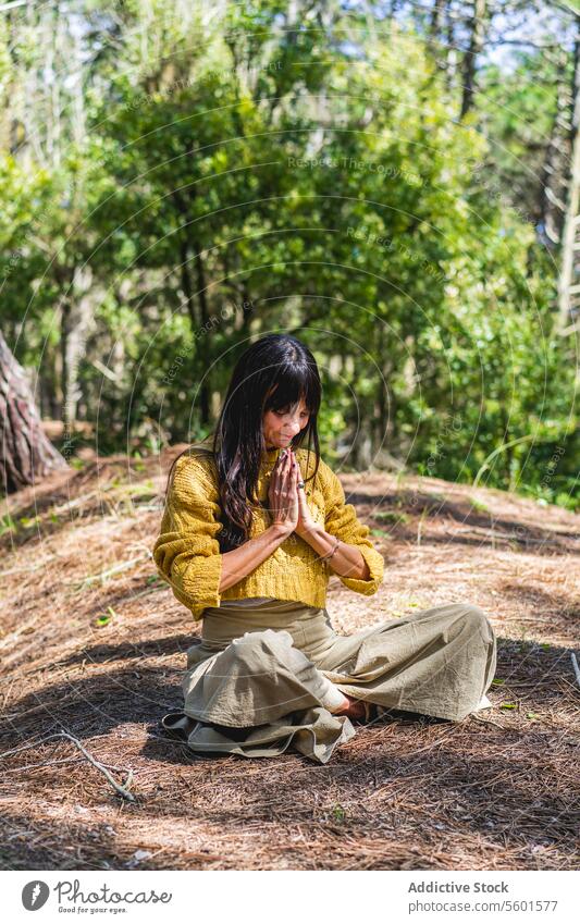 Woman with hands clasped meditating on the woods. Vertical Shot Human Hand asana balance breathe breathing calm calmness clasping copy space copy-space