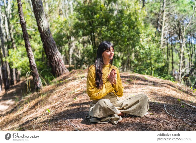 Woman with hands clasped meditating on the woods Human Hand asana balance breathe breathing calm calmness clasping eyes closed female forest harmony