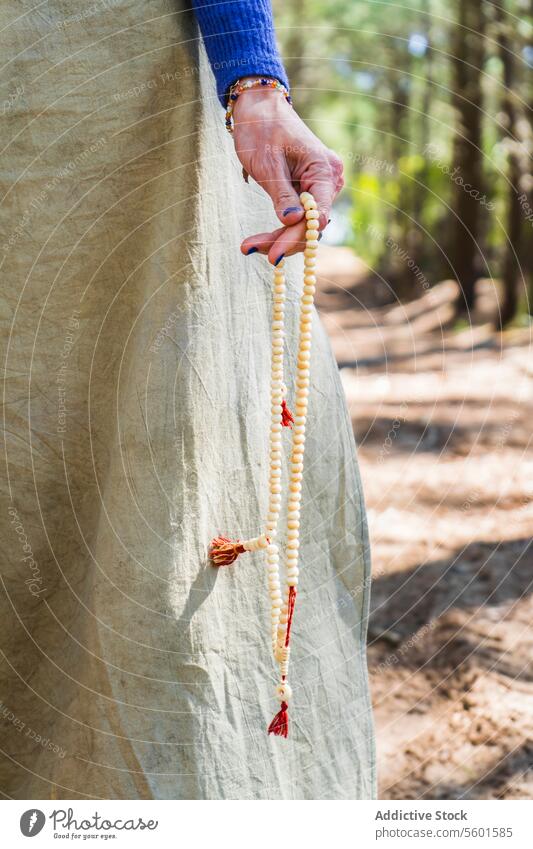 Close up of a japa mala holded by a woman hand - a Royalty Free