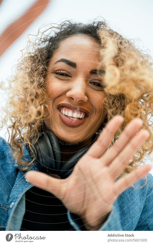 Cheerful ethnic woman with camera headphones cheerful happy curly hair smile female selfie african american positive black gadget joy device music together