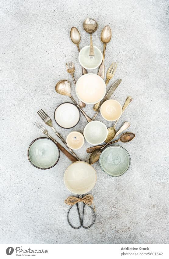 Rustic Kitchen Utensils and Bowls Flat Lay in a christmas tree shape rustic kitchen utensils bowls flat lay overhead view textured background arrangement