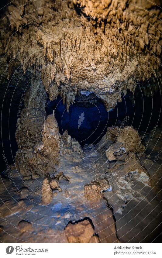 Subterranean landscape of stalactite structures hanging from the cave sailing in Cenote Dos Ojos, Mexico formations cave ceiling intricate dramatic dark waters