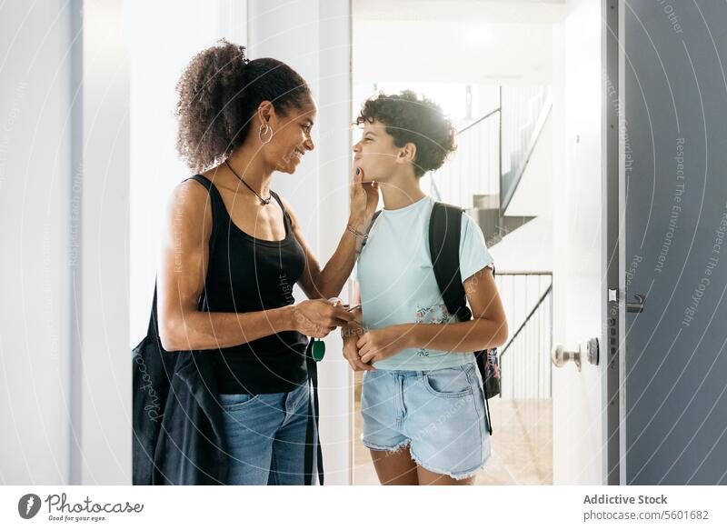 Mother and her daughter arriving home Family Preteen daughter adorable affectionate after school arrive bonding cheerful child childhood children cute day door
