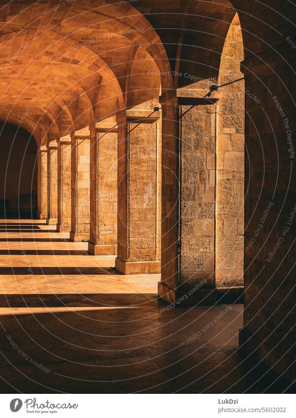 Photo of stone arcades with warm light and shadows Manmade structures Architecture Portasandstone Stone Arcade architecture battles Weser Arcades Town religious