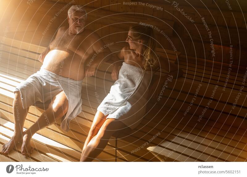 Couple in wellness spa relaxing in finnish wooden sauna couple old harmony fitness friends steam hot stone hotel room bucket sweat wellness bath