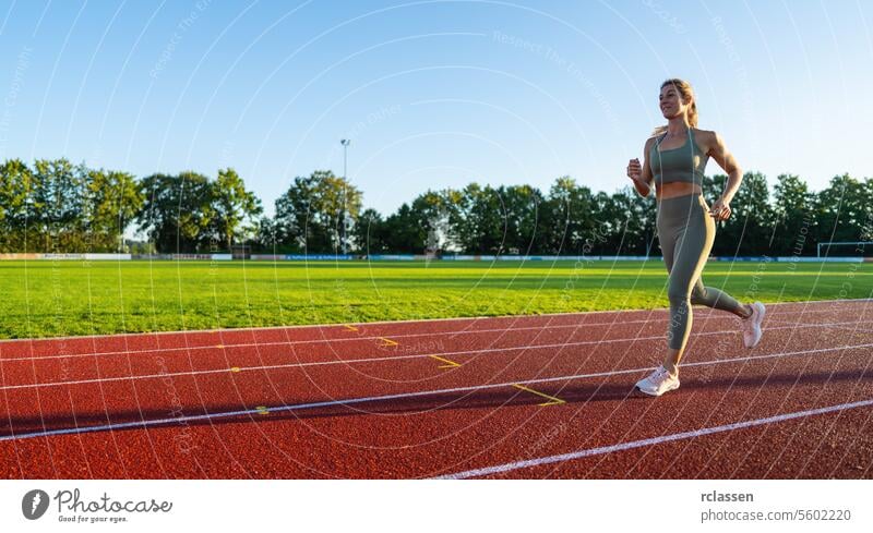 Woman jogging on a sunny running track event speed woman running sunlight athlete sports healthy lifestyle athletic wear running shoes outdoor exercise