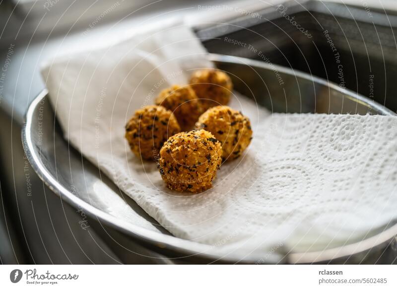 appetizer of fried potato balls with herbs in kitchen of a restaurant. Food Photography Concept image protein dinner hotel drain gourmet crispy golden brown