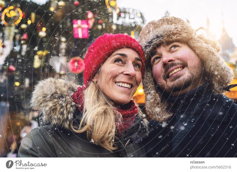 happy couple of tourist on Christmas Market in front of tree at winter time friends mulled wine boyfriend beard tourism dating fair travel love new year