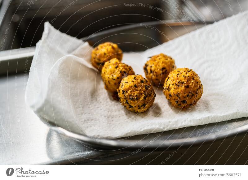 Luxurious appetizer of fried potato balls with herbs in kitchen of a restaurant. Food Photography Concept image protein dinner hotel drain gourmet crispy